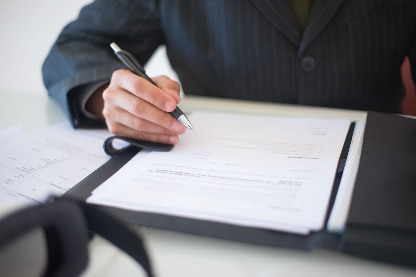 Signing business documents at a desk