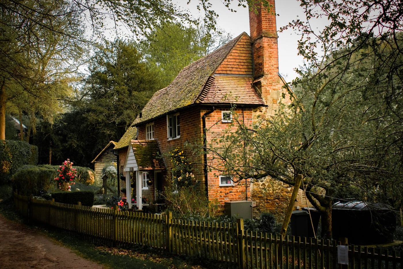 Brick cottage surrounded by a green garden