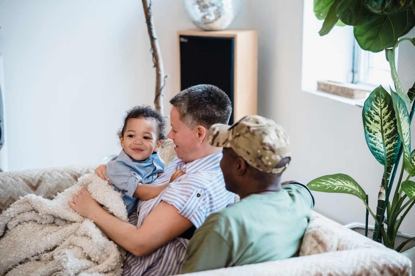 Family sitting together on a sofa in a bright living room