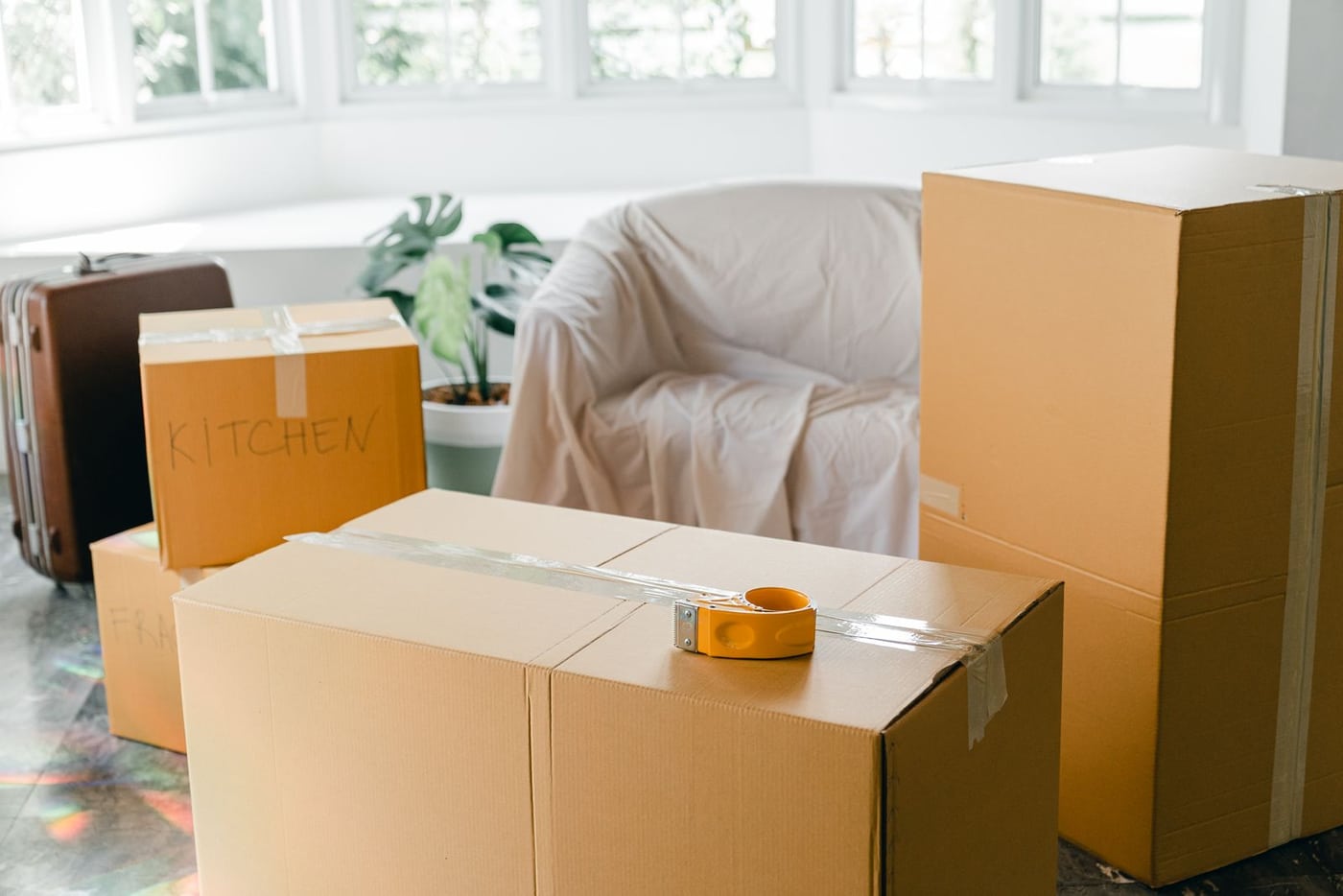 Packed moving boxes in a bright room before relocation