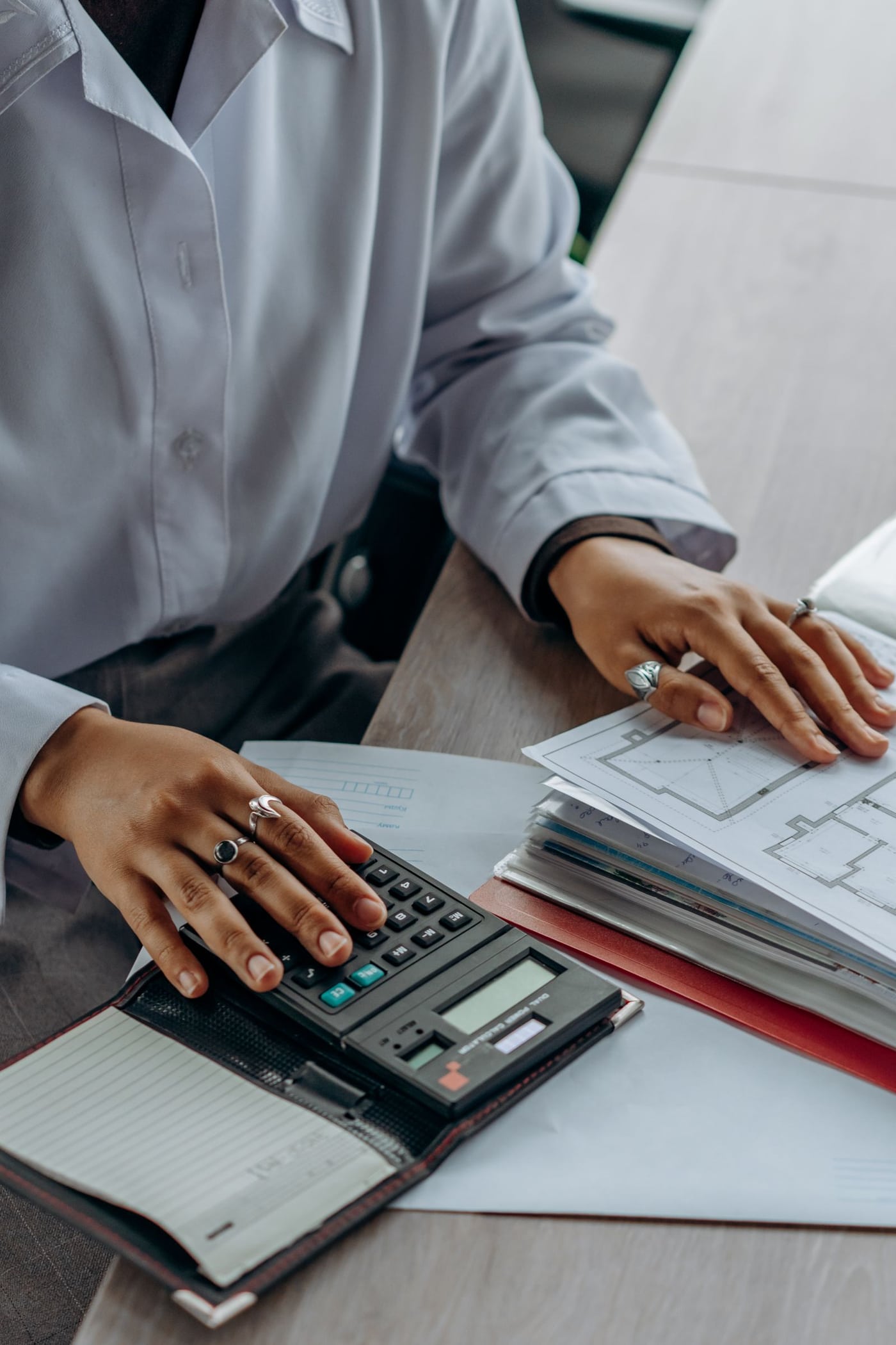 Reviewing paperwork with a calculator at a desk
