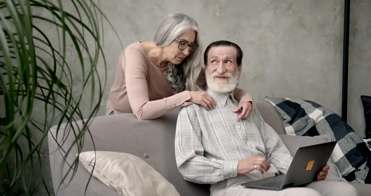 Older couple using a laptop together at home