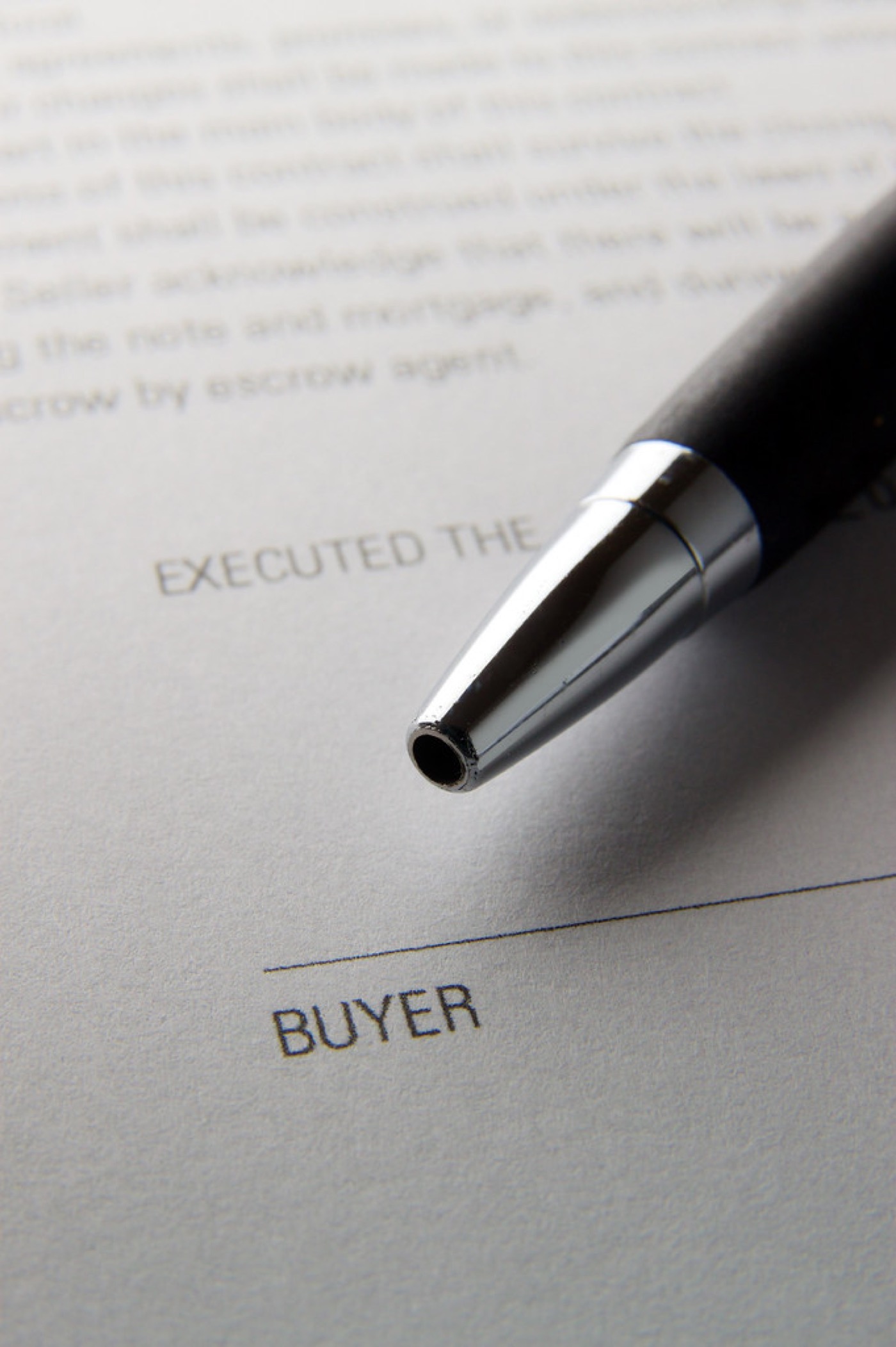 A close-up of a signature being written on a contract