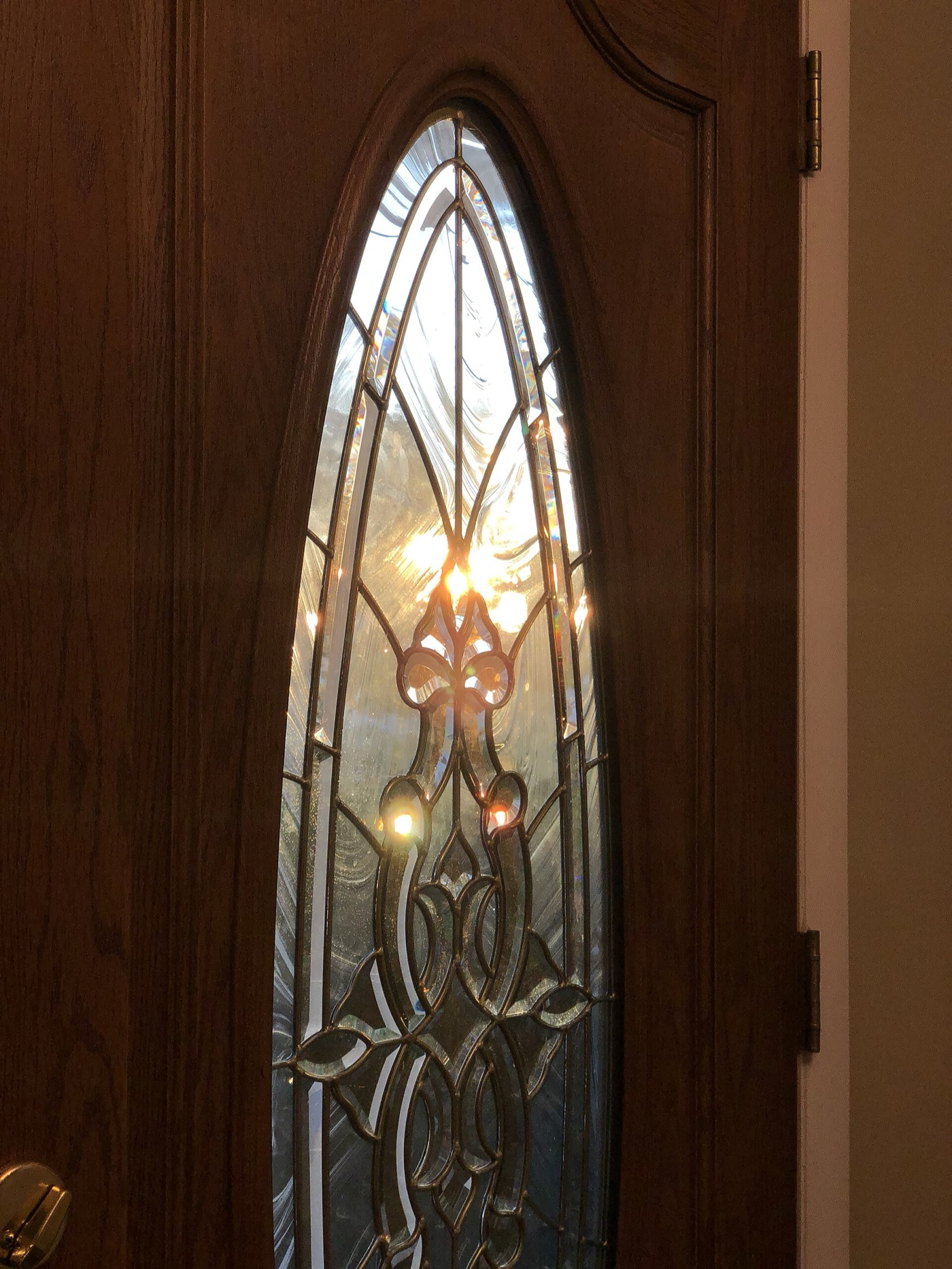 Morning sun through the decorative glass of a front door