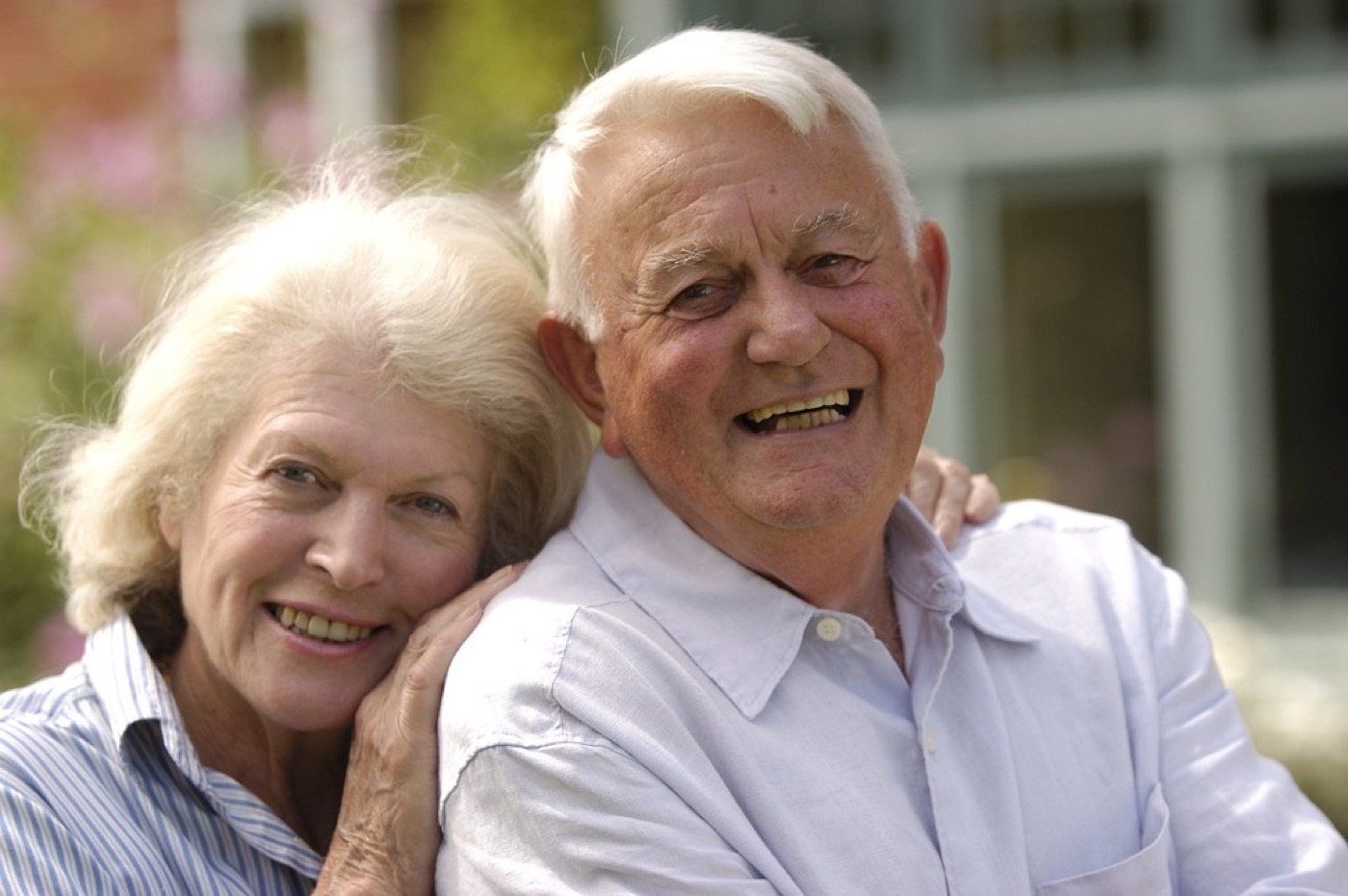 An older couple smiling together at home