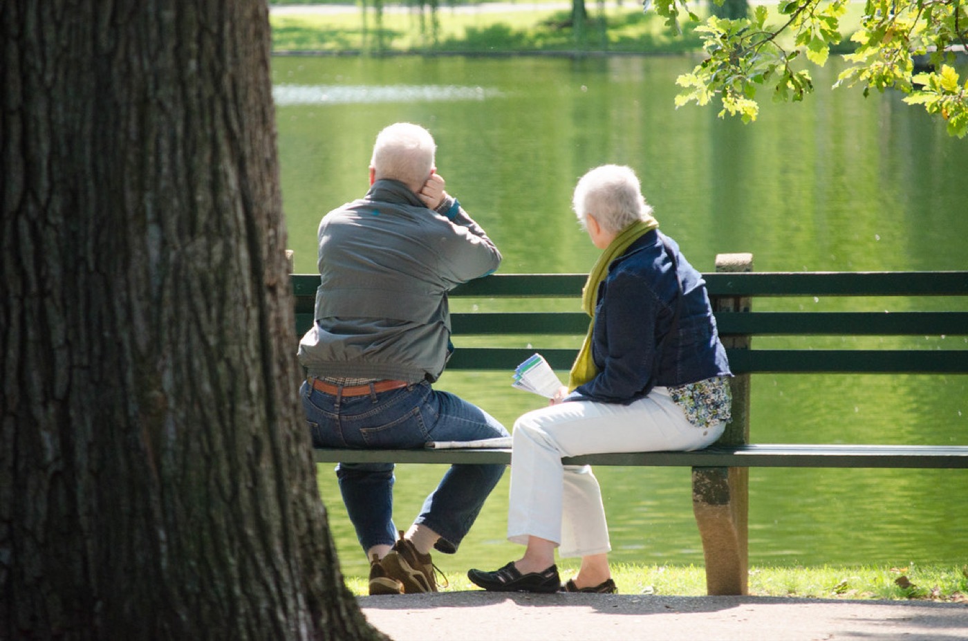A couple walking beside a pond