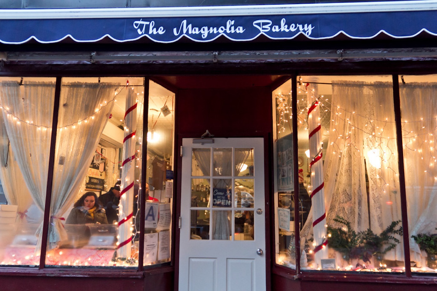 An independent neighbourhood bakery lit up in the evening