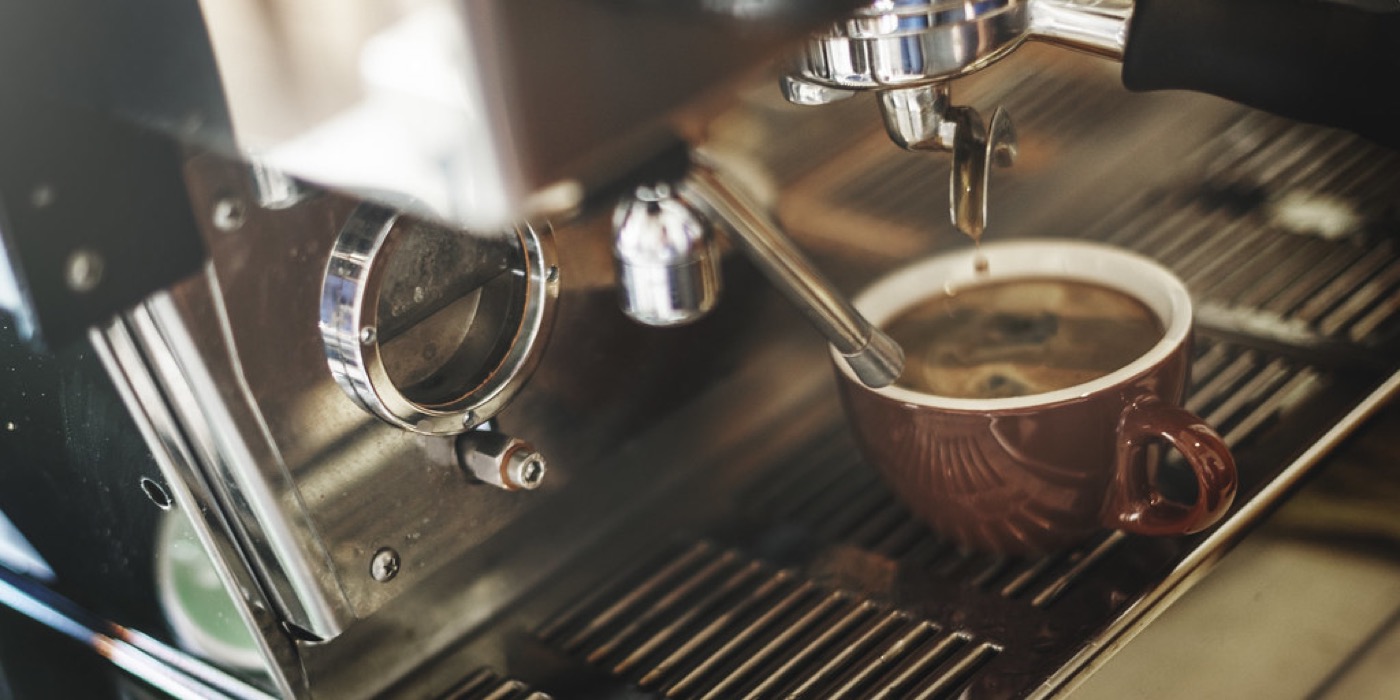 Serving a customer at the counter of a small coffee shop